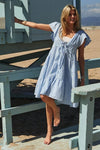 Complete front view of the azure V-neck tiered dress with soft cap sleeves, designed with a flattering tiered hemline and comfortable fit—ideal for daytime events and casual elegance.