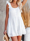 Woman wearing a white ruffled scoop neck sleeveless romper with a flowy tiered design, styled for a casual summer look.

