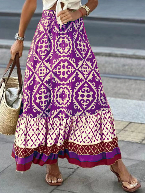 A stylish geometric print elastic waist maxi skirt in earthy tones, paired with a tied white top, ideal for casual and boho-inspired outfits.