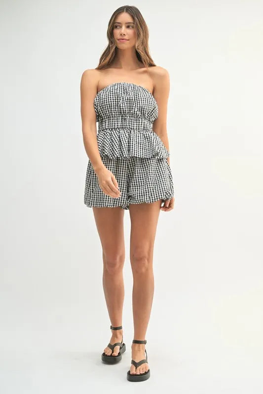 A mid-length image focusing on the structured top with subtle short sleeves and the smooth waistband of the shorts.

