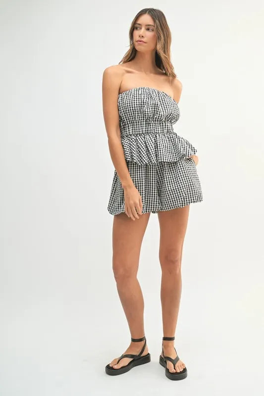 A fabric detail close-up showing the breathable, soft cotton material with its iconic black and white gingham pattern.

