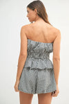 A full back image showing the fitted back of the top and the clean-cut shorts, offering a complete view of the set’s silhouette from behind.

