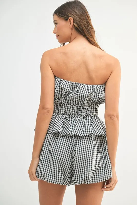 A full back image showing the fitted back of the top and the clean-cut shorts, offering a complete view of the set’s silhouette from behind.

