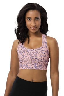  Woman wearing the Girl Power Print Pink Racerback Sports Bra. Featuring a vibrant pink "Girl Power" design, high-impact support, and a racerback fit for gym workouts and activewear.