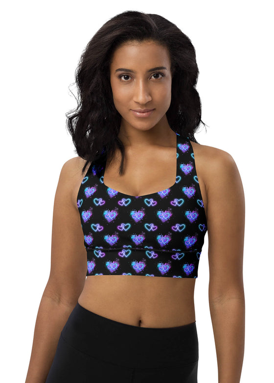 Woman wearing the Glowing Hearts Black Racerback Sports Bra. Featuring glowing heart patterns on a sleek black backdrop, providing high-impact support for intense workouts and stylish activewear.
