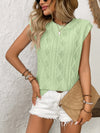 Model wearing green eyelet top from the front, showcasing the intricate pattern and soft cap sleeve with a casual feminine charm.

