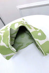  A close-up view of the green flower-knitted handbag, emphasizing the vibrant flower pattern in a striking green shade.