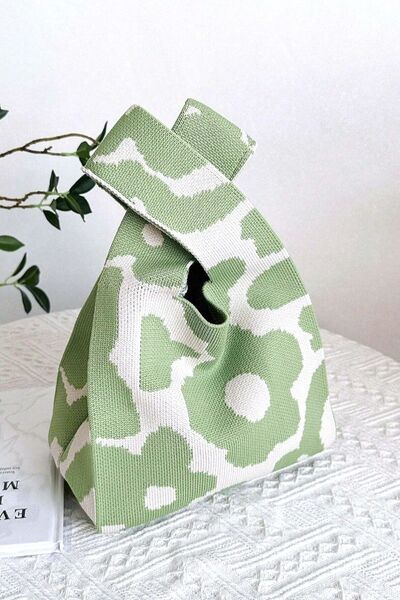 A stylish green flower-knitted handbag, showcasing intricate floral patterns in a vibrant shade of green. Perfect for a fresh and chic look.

