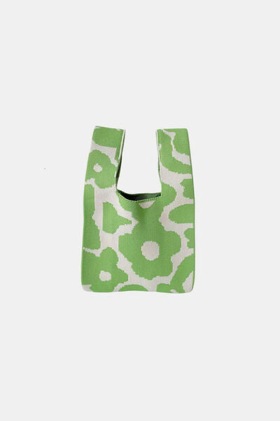 Side view of the green flower-knitted handbag, highlighting the floral design and detailed craftsmanship. A great addition to any casual outfit.