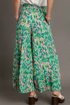 Back view of the green printed pants showcasing the comfortable waistband and flowing shape from behind.

