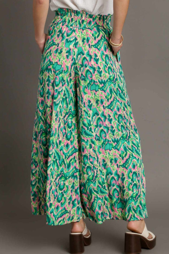 Back view of the green printed pants showcasing the comfortable waistband and flowing shape from behind.

