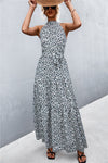 Grey maxi dress with all-over print and tie waist detail—sophisticated neutral tone perfect for minimalist summer wardrobes.