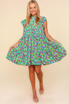 Front view of the Haptics Frilled Mock Neck Ditsy Floral Dress featuring flutter sleeves and a tiered knee-length design.