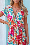 Hot pink floral tie waist maxi dress with short sleeves and a flattering neckline, designed with a bold all-over print and a soft flowing fabric.