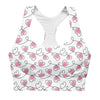 Closeup of heart print on Infinite Hearts white sports bra. Features double-layered front, removable padding, and sleek compression longline design.