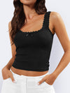 Model styled in the Lace Detail Square Neck Tank with black trousers, showcasing a chic and feminine look.