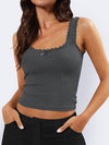 Woman wearing the Lace Detail Square Neck Tank in gray, featuring delicate lace trim and a flattering square neckline, styled with black pants.

