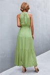 Back view of leaf print tie waist maxi dress featuring relaxed flow, sleeveless cut, and soft fabric—perfect for effortless outdoor elegance.
