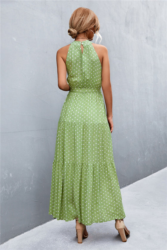Back view of leaf print tie waist maxi dress featuring relaxed flow, sleeveless cut, and soft fabric—perfect for effortless outdoor elegance.