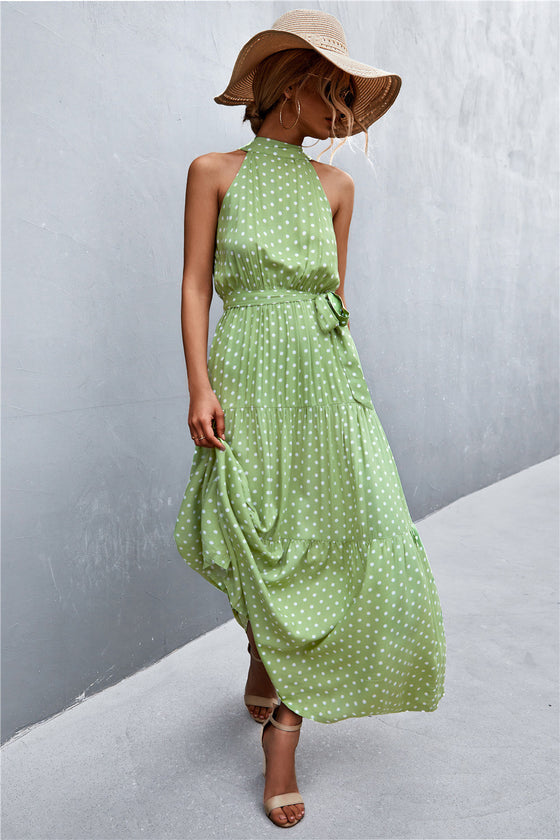  Full front image of leaf-printed maxi dress with tie waist—tropical-inspired sleeveless style for summer travel, brunches, or beachside looks.