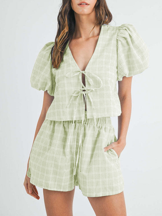 Front view of the light green V-neck puff sleeve top and shorts set, showing the delicate color and playful puff sleeve design. The shorts complete the relaxed yet fashionable look.

