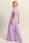 A back-facing image capturing the seamless back design of the top and the clean, tailored drape of the matching wide-leg pants.

