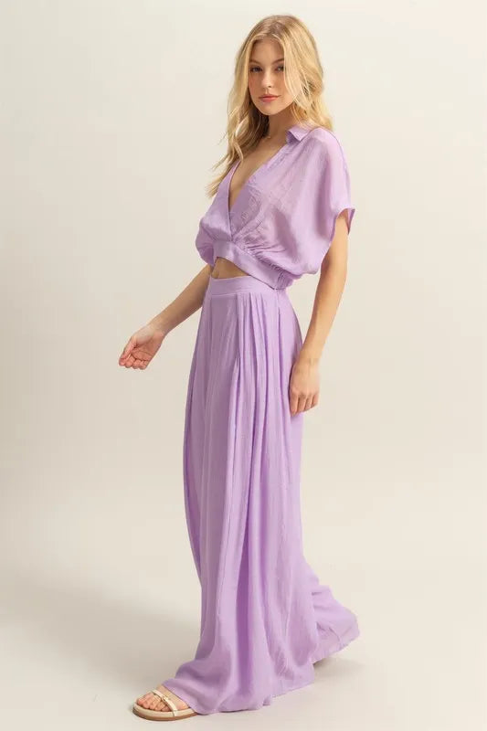 A side view showing the outfit’s relaxed top and the fluid movement of the wide-leg pants for a comfortable yet polished ensemble.

