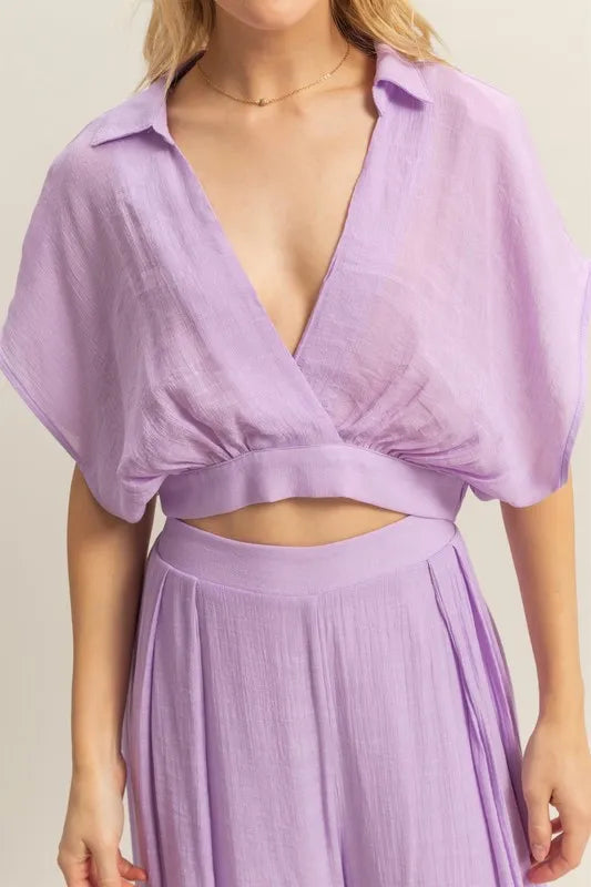 A close-up view of the top’s neckline and upper bust area, focusing on the smooth fabric texture and subtle stitched details for added refinement.

