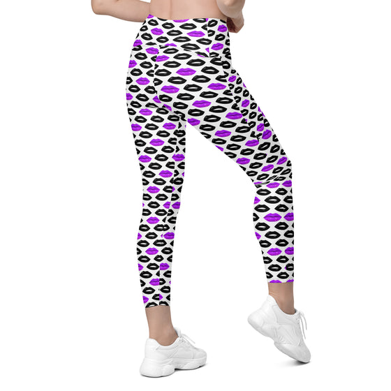 Back view of women's white leggings with bold purple and black lips print. High waisted gym leggings with pockets and sculpting compression fit.