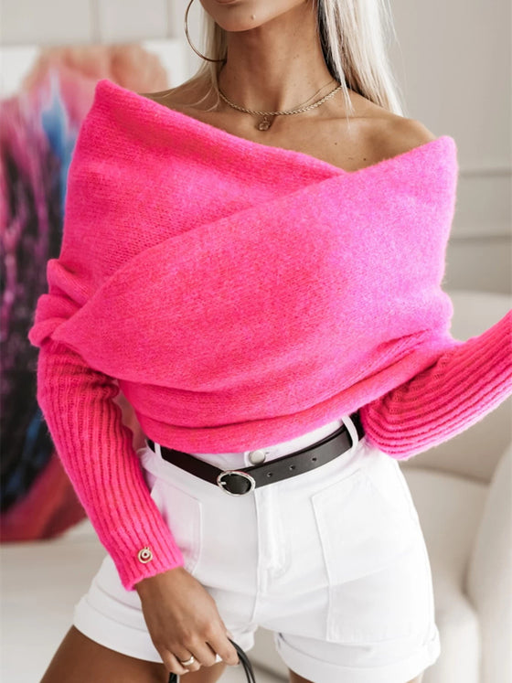 Woman wearing a long sleeve cropped knit top in a neutral beige color, paired with white high-waisted shorts, perfect for a casual outing.

