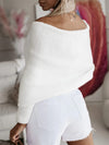 Back view of a long sleeve cropped knit top in neutral beige, styled with high-waisted white shorts.