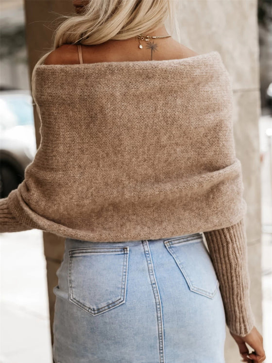 Back view of a long sleeve cropped knit top in neutral beige, styled with high-waisted white shorts.