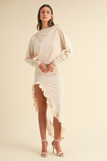  Model wearing the Mable Backless Asymmetric Ruffle Hem Dress in beige, featuring a cowl neckline, backless design, and elegant ruffle hemline, perfect for formal occasions.