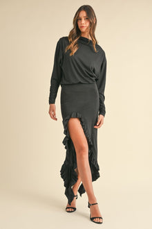  Model wearing a black Mable Backless Asymmetric Ruffle Hem Dress with a cowl neckline, backless design, and dramatic ruffle detailing, perfect for special occasions.

