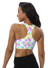 Back view of the Melting Hearts Print White Racerback Sports Bra. Racerback design for unrestricted movement, moisture-wicking fabric, and high-impact support for gym sessions and running.