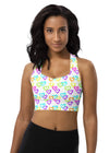 Woman wearing the Melting Hearts Print White Racerback Sports Bra. Featuring a unique melting hearts design, high-impact support, and a racerback fit for gym workouts and activewear.