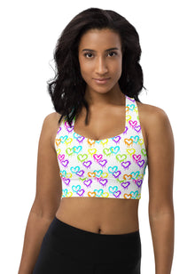  Woman wearing the Melting Hearts Print White Racerback Sports Bra. Featuring a unique melting hearts design, high-impact support, and a racerback fit for gym workouts and activewear.