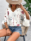 Model in a minimal, breezy white blouse with subtle floral prints and half sleeves, ideal for warm-weather layering.