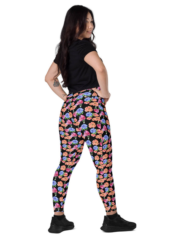 Model sitting back in Black Floral High Waisted Leggings with Pockets, highlighting the beautiful floral design and supportive fit for both active and casual lifestyles.