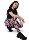 Model sitting front view in Black Floral High Waisted Leggings with Pockets, featuring a high-rise fit and convenient pockets, perfect for a stylish workout or casual day out.