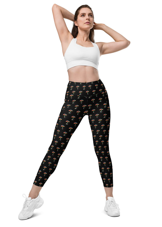 Model wearing Zen Frog black high-waisted leggings with all-over frog print, showing front view with side pockets for a convenient, stylish workout.