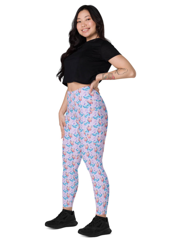 Model sitting sideways in lavender butterfly print high-waisted leggings, featuring side pockets for added convenience and comfort.