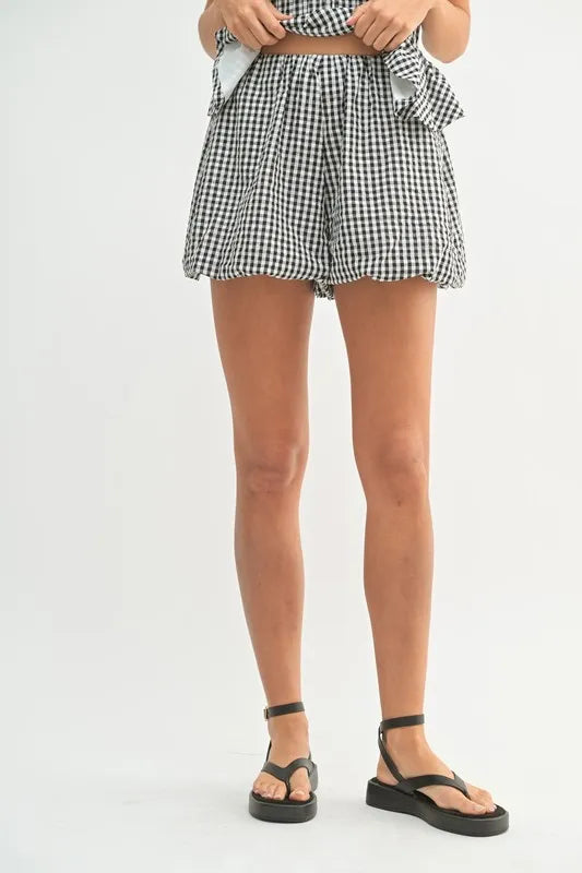A front-skirt shot of the model wearing the gingham outfit, capturing the sunny, playful vibe of this summer-ready two-piece.

