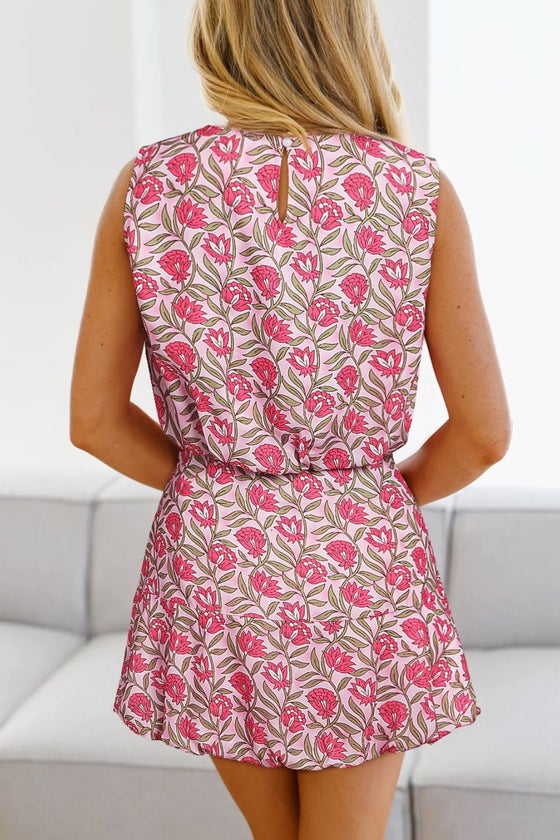 Back view of the model in the floral tank and mini skirt set, highlighting the tank top’s strap design and the skirt’s comfortable fit with the full floral print continuing beautifully.

