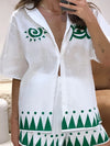  Woman modeling a white button-down printed outfit set with a clean, crisp top and coordinated floral skirt, perfect for light, sunny weather.