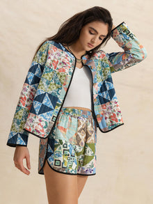  Model showcasing a vibrant multicolor outerwear and shorts set from the front, perfect for streetwear and bold fashion lovers.