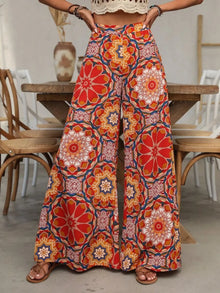  A vibrant, multicolor printed design on wide-leg pants, captured from the front to showcase their relaxed, flowing silhouette and the unique patterns that add a pop of color and style.

