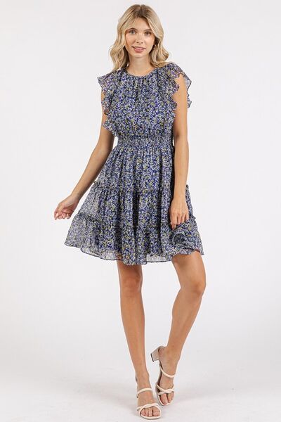 A front shot that draws attention to the charming ruffled accents, floral design, and airy flow of the mini dress, perfect for day-to-night wear.