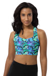 Woman wearing a neon foliage seamless sports bra with vibrant turquoise and lime green prints. High-impact support, racerback design, perfect for gym workouts, running, and active wear.