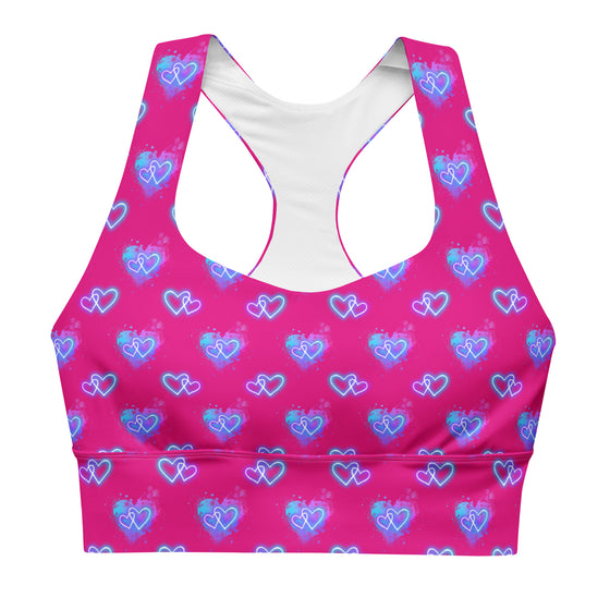 Front view of the Neon Heart Violet Red Racerback Sports Bra. Featuring a vibrant neon heart print, high-support compression fabric, removable padding, and a snug fit for intense workouts and active lifestyles.